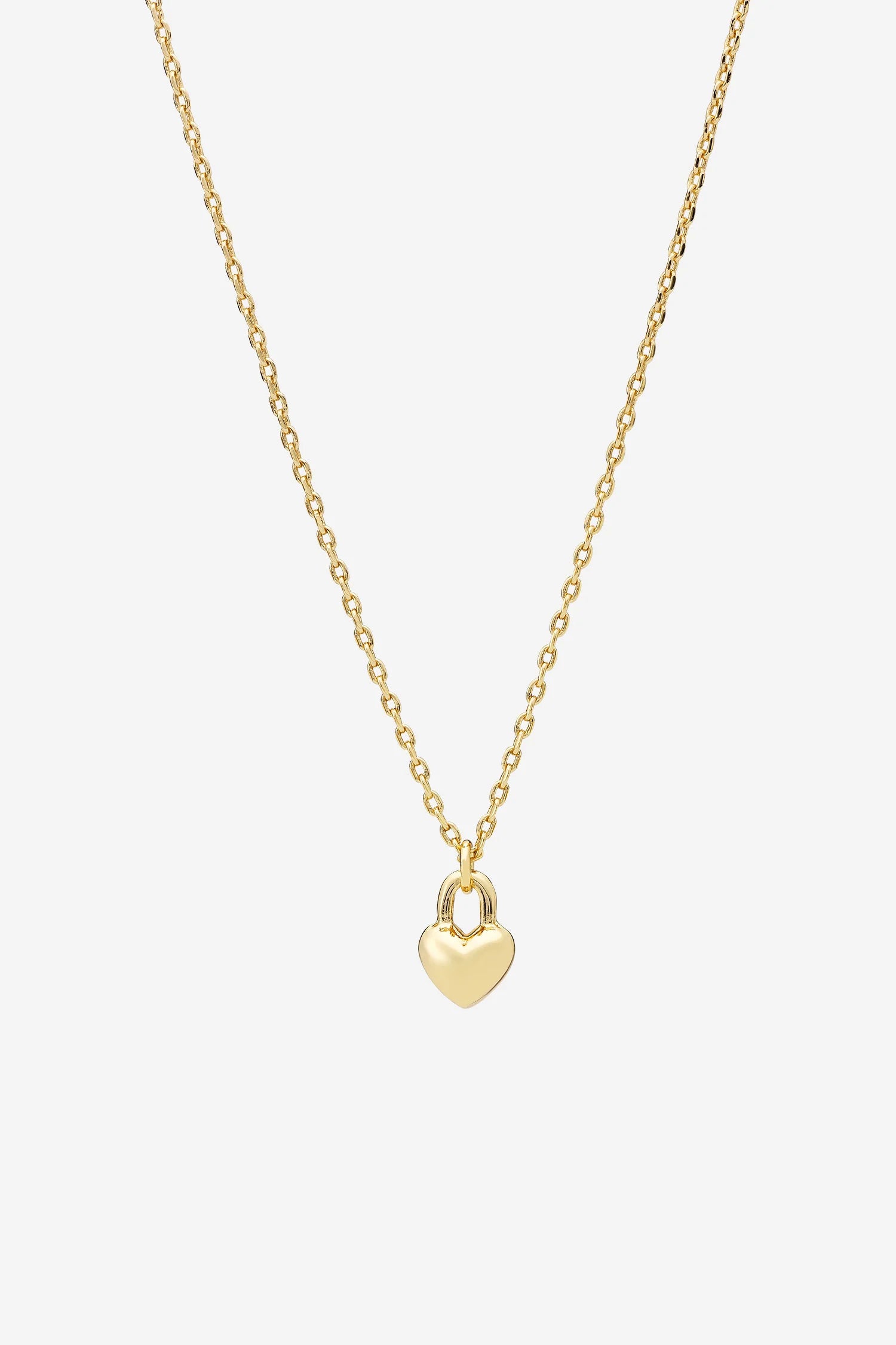 A delicate gold chain necklace with a small heart-shaped lock pendant against a white background.