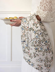 Bespoke Letterpress Camellia Tree Linen Tea Towel draped over arm with floral and bird motif