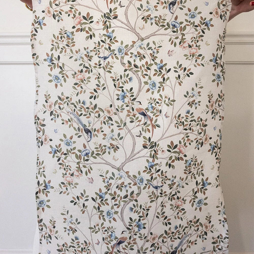 Bespoke Letterpress Camellia Tree Linen Tea Towel with floral and bird design held up for display