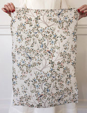 Bespoke Letterpress Camellia Tree Linen Tea Towel with floral and bird design held up for display