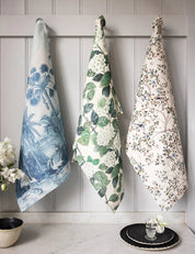 Bespoke Letterpress Subcontinent Linen Tea Towel hanging with floral and botanical designs