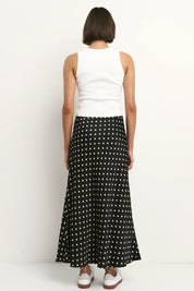 Black white polka dot satin maxi skirt back view bias cut design flattering flowy silhouette soft satin fabric comfortable elasticated waistband classic women’s fashion