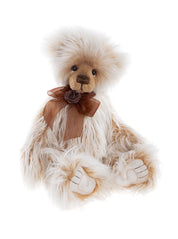 Charlie Bears Ari plush bear with fluffy cream and caramel fur, dark eyes, sculpted paw pads, and a brown organza bow with a rose detail.