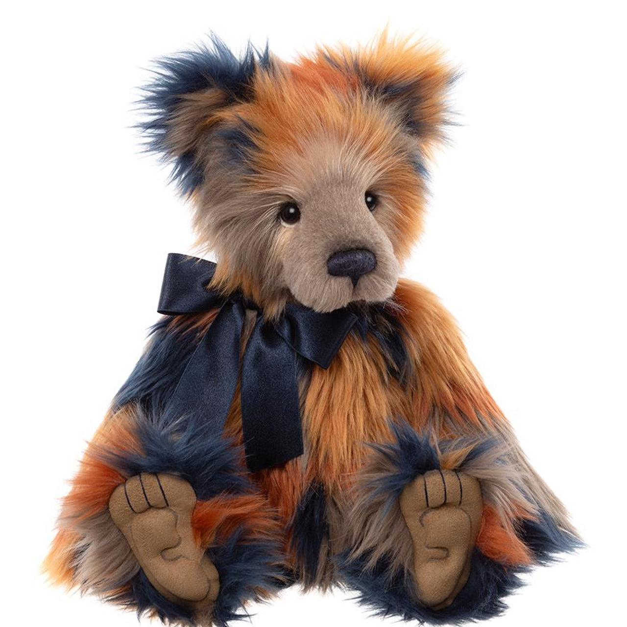 Charlie Bears Wilkinson plush bear with long, multicolored fur in shades of orange, navy, and beige, detailed paw pads, and a navy satin bow.