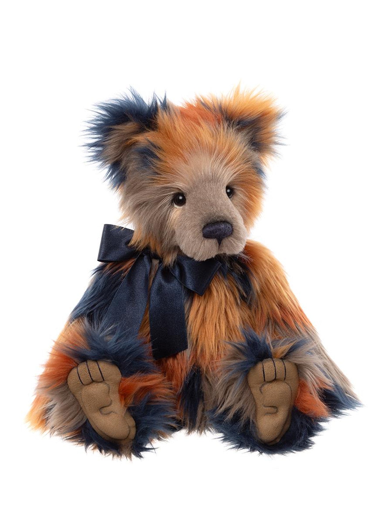 Charlie Bears Wilkinson plush bear with long, multicolored fur in shades of orange, navy, and beige, detailed paw pads, and a navy satin bow.