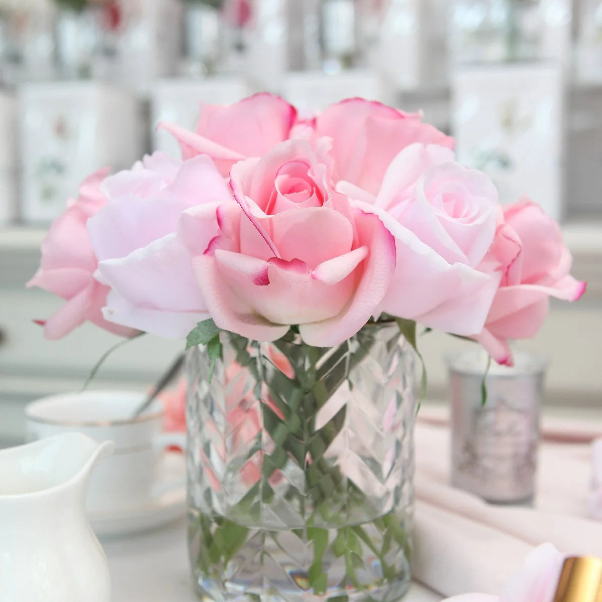Pink mixed rose buds in a clear herringbone vase, Côte Noire artificial flower arrangement.