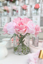 Pink mixed rose buds in a clear herringbone vase, Côte Noire artificial flower arrangement.