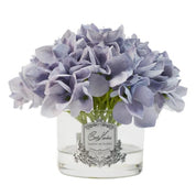 Cote Noire blue hydrangea arrangement in clear vase with lifelike natural touch petals and perfumed finish