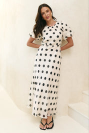 Cream black polka dot puff sleeve maxi dress back view flattering fitted waist tie detail bias cut flowy skirt elegant timeless women’s fashion dress