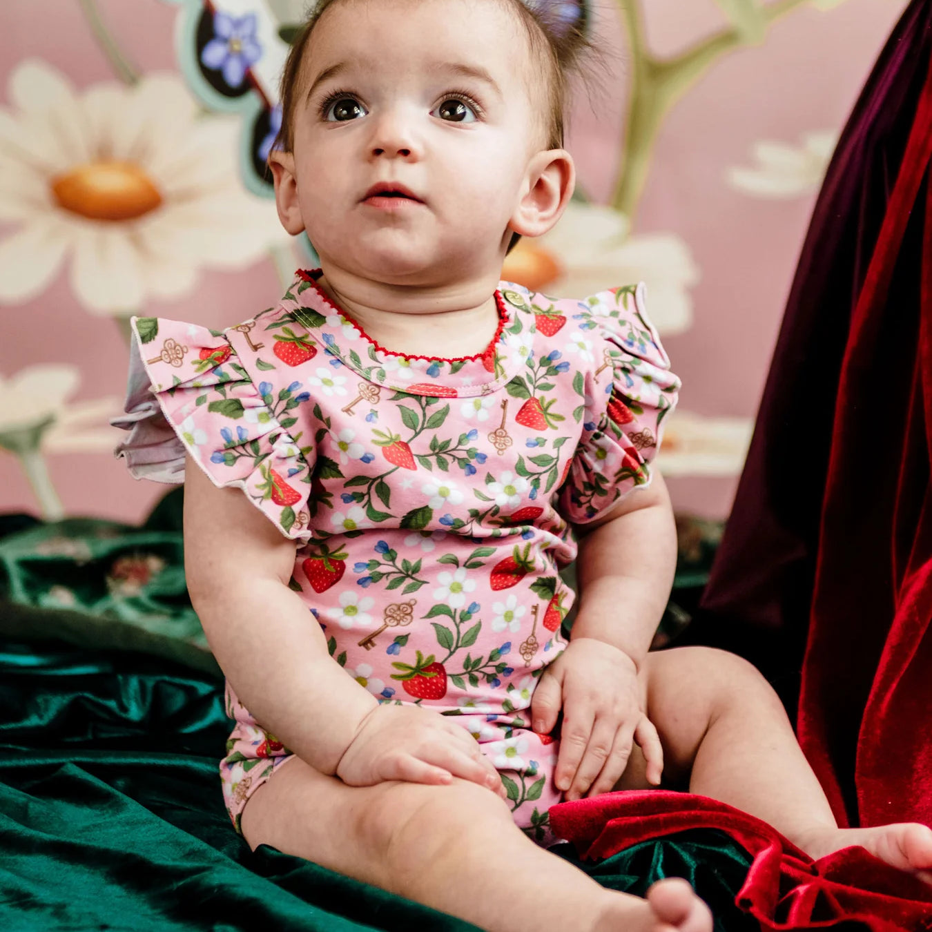 Toddler in Fleur Harris Bijou Bodysuit featuring pink Hearts Floral all-over print and frill detailing.