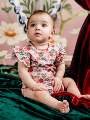 Toddler in Fleur Harris Bijou Bodysuit featuring pink Hearts Floral all-over print and frill detailing.