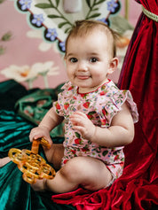 Baby girl wearing Fleur Harris Bijou Bodysuit in Hearts Floral print with frill sleeves from the All My Hearts collection.