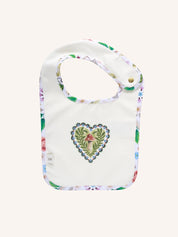 Fleur Harris Dandy Duo Bib with All My Hearts central heart motif featuring mushroom illustration, floral trim, and gold snap closure.