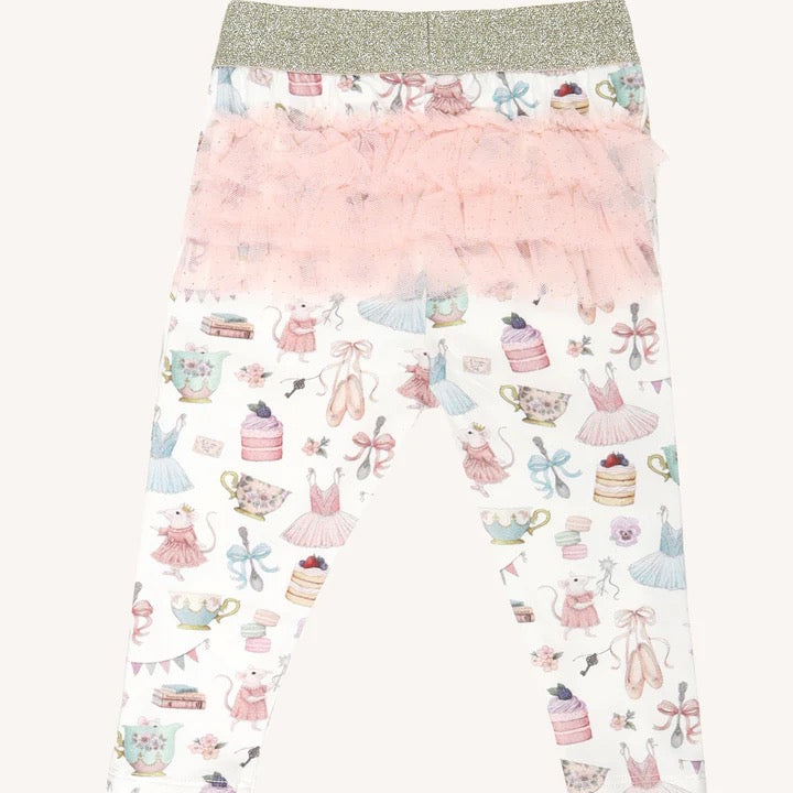 Flat lay of patterned leggings with gold waistband and layered pink frill tutu detail on back
