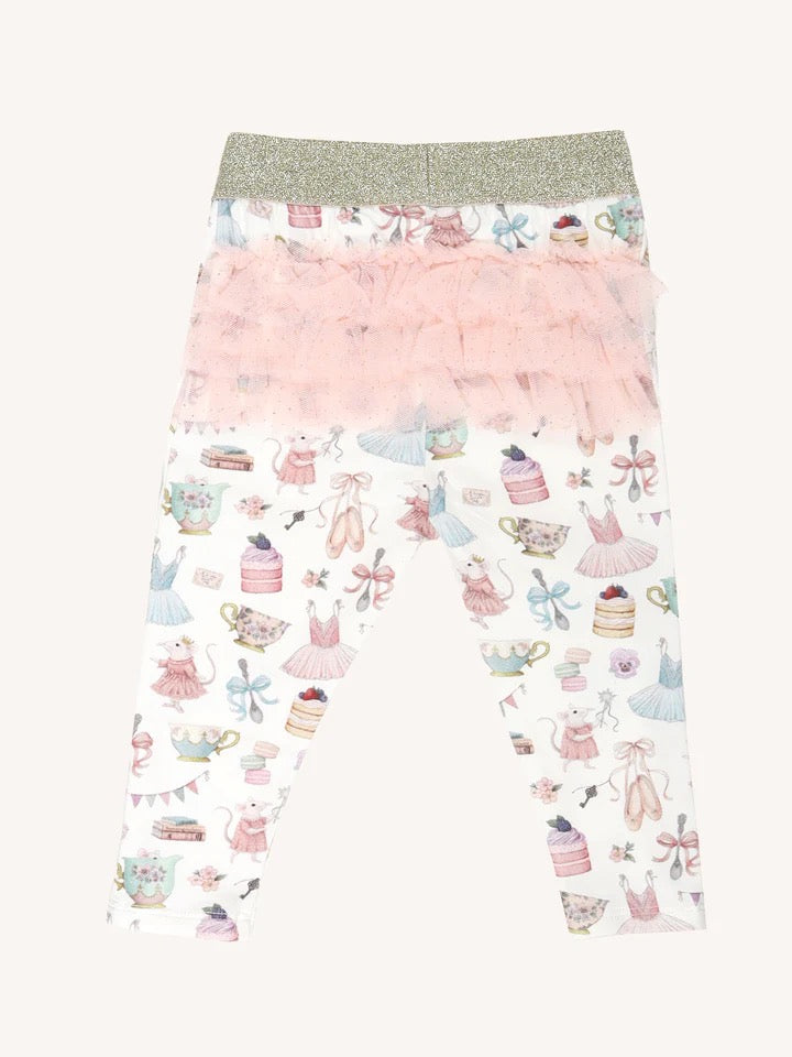 Flat lay of patterned leggings with gold waistband and layered pink frill tutu detail on back