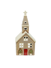 Front view of beige ceramic tea light church with red door, star-topped steeple, and Christmas trees at the entrance