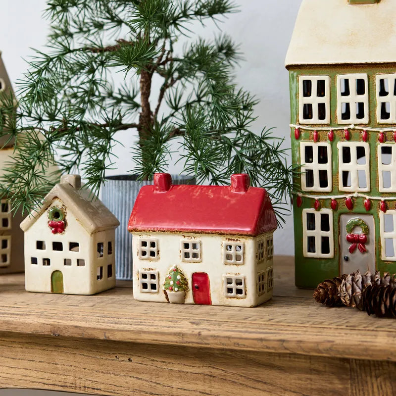 Alsace Tea Light Cottage by French Country, ceramic Christmas house with red roof, styled in festive holiday village scene.