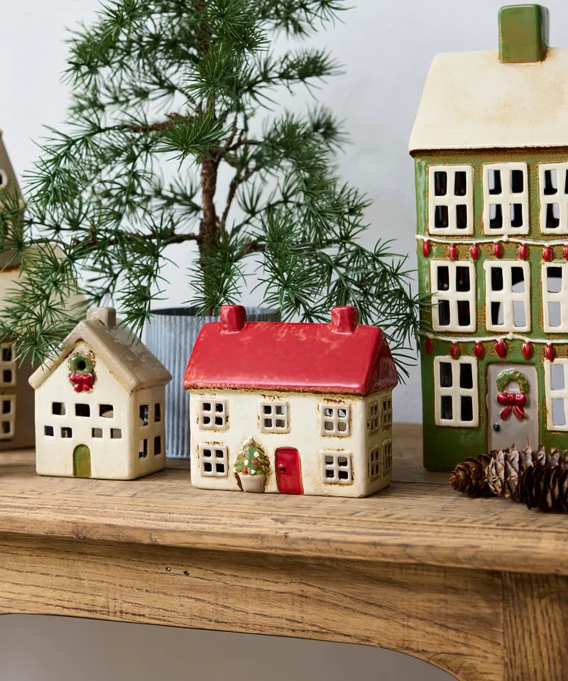 Alsace Tea Light Cottage by French Country, ceramic Christmas house with red roof, styled in festive holiday village scene.
