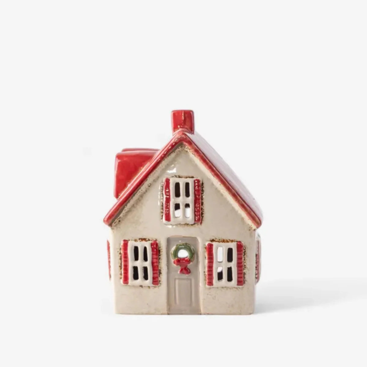 Cream ceramic tea light cottage with red shutters, red roof, and festive wreath on the door