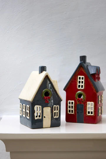 French Country Alsace Tea Light Cottages in navy with wreath and red with wreath, styled as part of a festive holiday village.