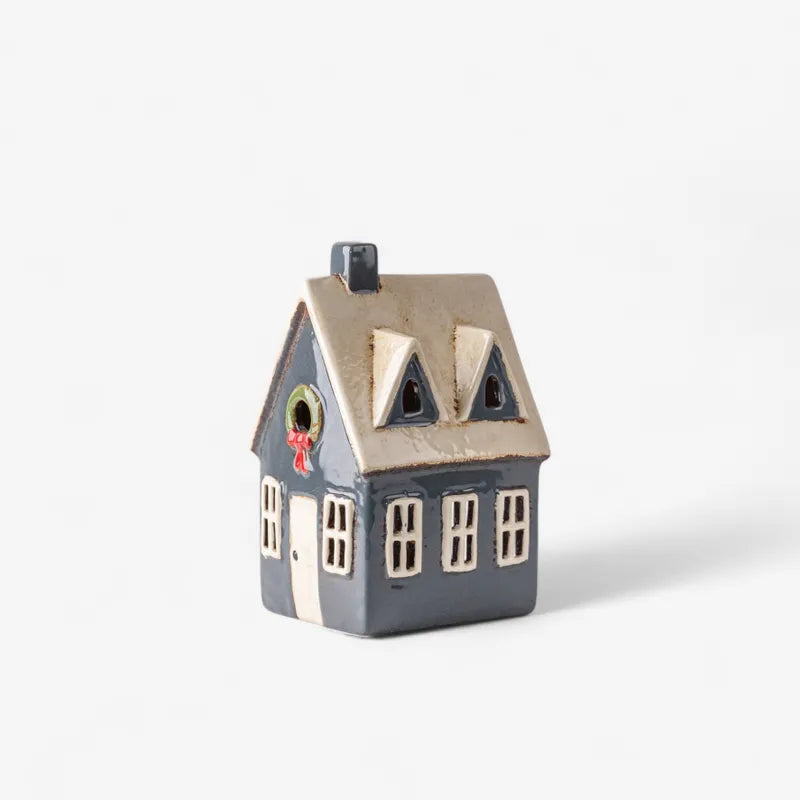 Ceramic Christmas tea light cottage by French Country, navy house with cream roof, hand-painted wreath and festive windows.