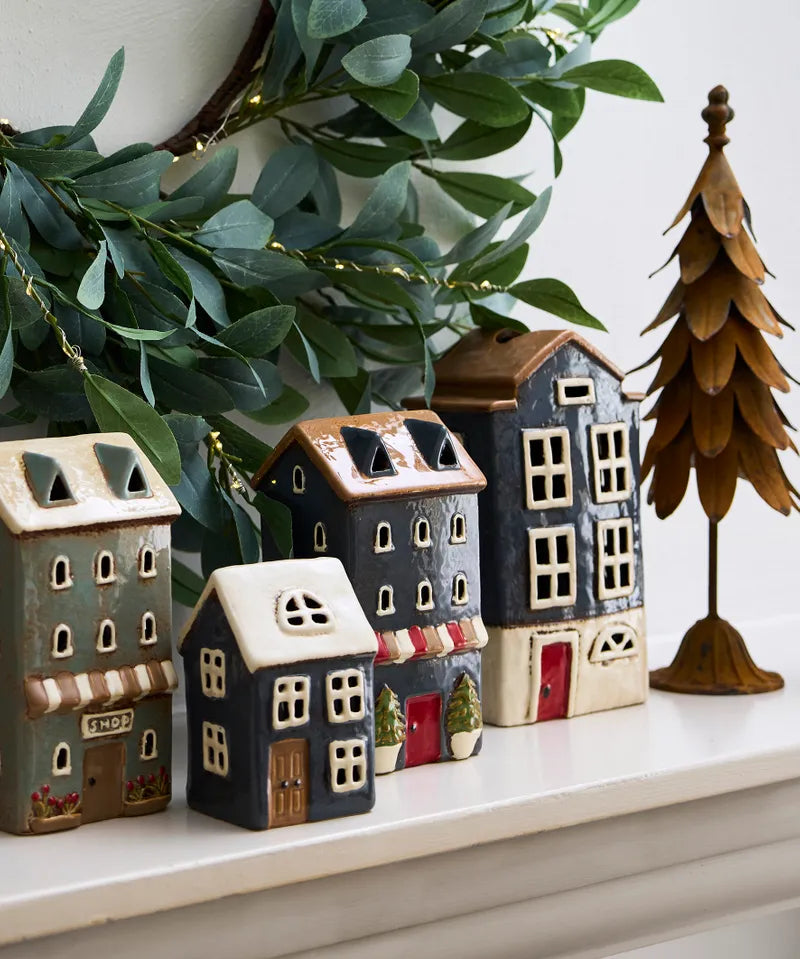 French Country Alsace Tea Light Shop navy ceramic house displayed with other tea light houses on mantel