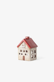 Small ceramic tea light house in white with red roof and brown door
