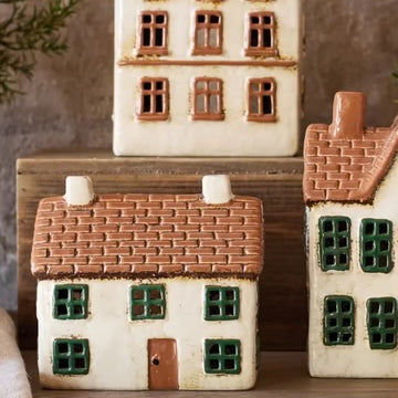 French Country Cotswolds Country Tea Light Cottage displayed with other ceramic tea light houses on wooden surface