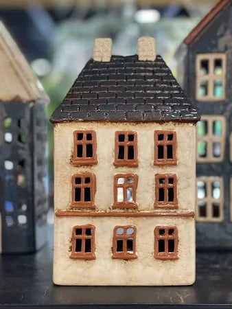 Close-up of French Country Cotswolds Country Tea Light Estate House with brown framed windows and tiled roof.