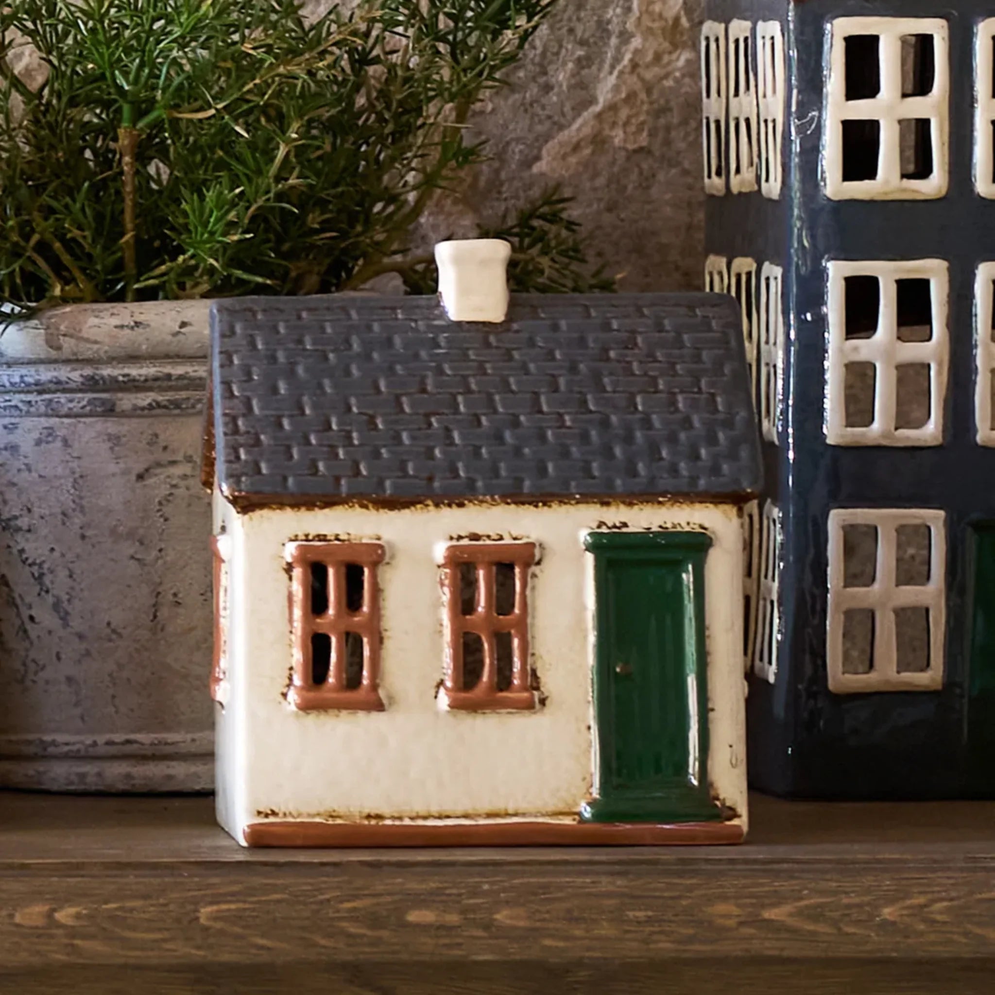 Display of French Country Cotswolds Country Tea Light Homestead on a wooden shelf with potted greenery.