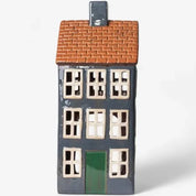 Front view of French Country Cotswolds Country Tea Light Grande Chalet with orange tiled roof and green door.