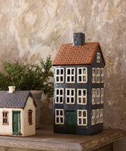 Grande Chalet ceramic tea light house styled in a rustic display with other cottage designs.