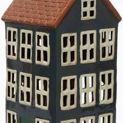 Tall ceramic tea light house in navy with terracotta roof and green door, featuring multiple window cutouts.