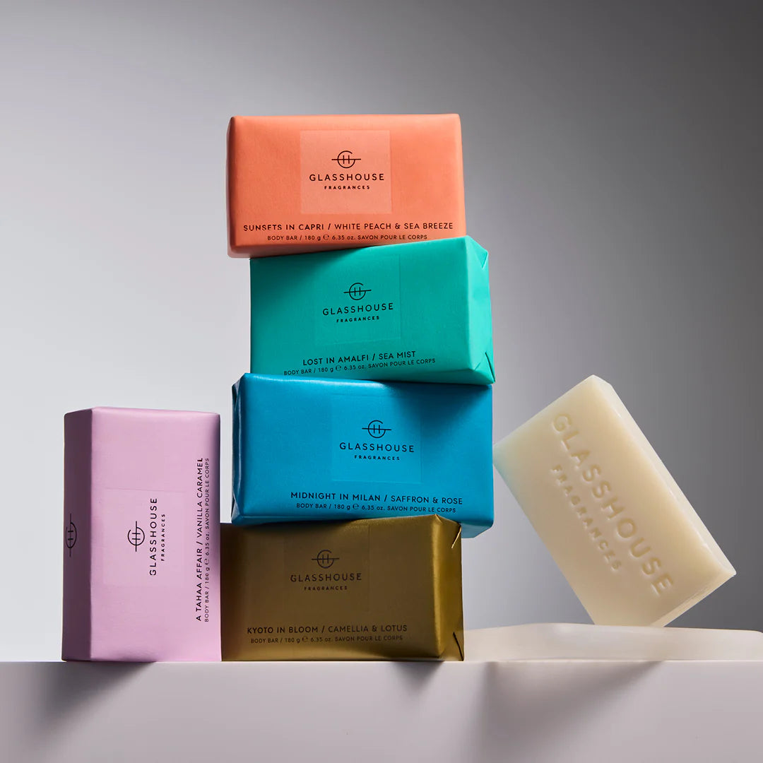 Assorted Glasshouse 180g Body Bars stacked together, including Kyoto In Bloom, Midnight in Milan, Lost in Amalfi, Sunsets in Capri, and A Tahaa Affair.