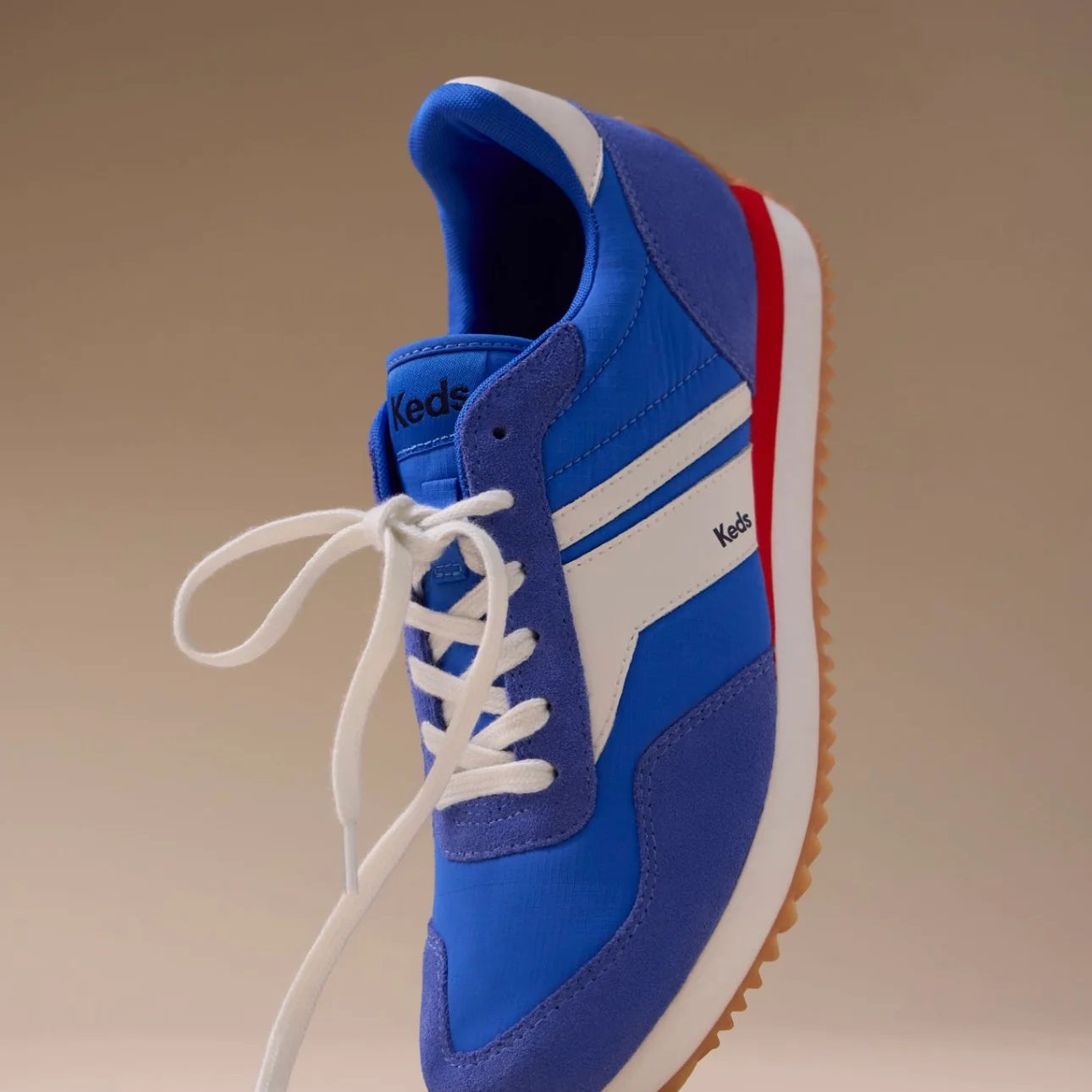 Keds Rena Nylon Suede sneaker in blue, white, and red shown at an angled floating view.