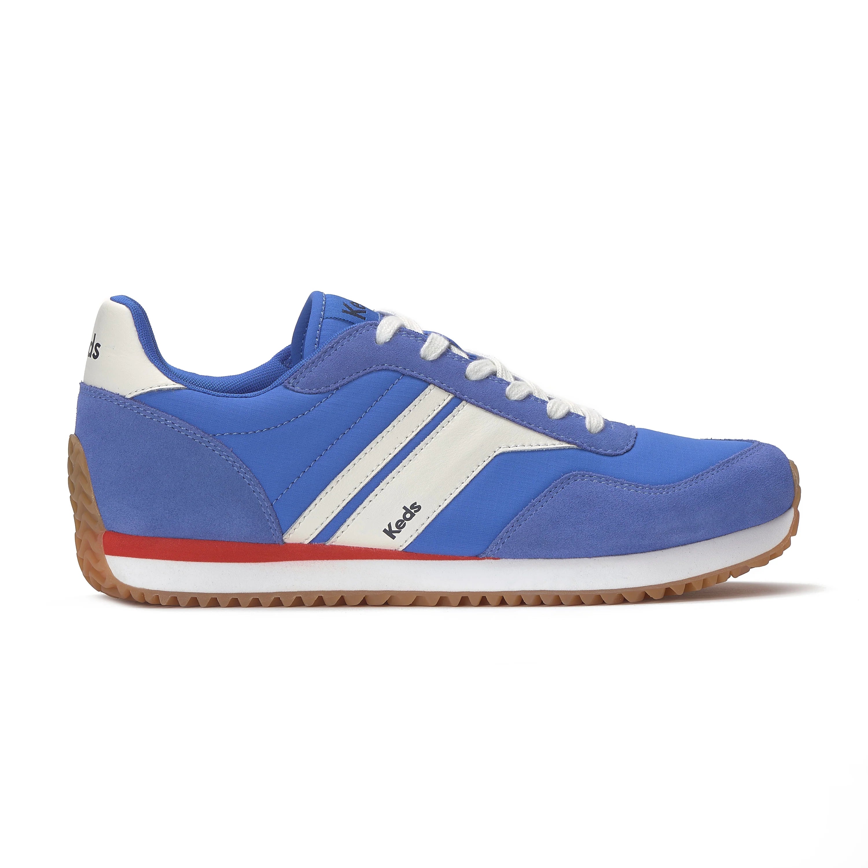 Side view of the Keds Rena Nylon Suede sneaker in blue with white stripes, red midsole accent, and gum sole.