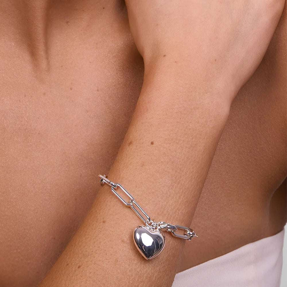 Model wearing LIBERTE Lotte Silver Heart Bracelet, chunky chain link bracelet with polished heart charm