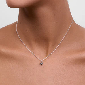 Model wearing LIBERTE Winnie Silver Heart Necklace, delicate silver chain with heart lock pendant styled on neckline