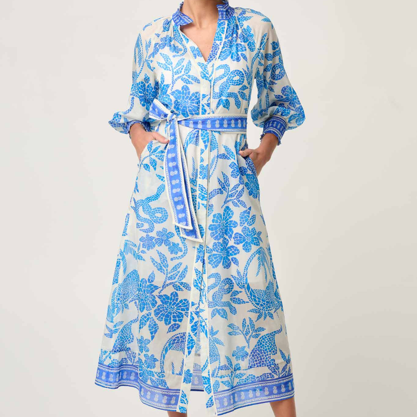 Front studio view of ONCE WAS Carmen Silk Cotton Maxi Dress in Azure Mosaic with tie belt and blue floral print.