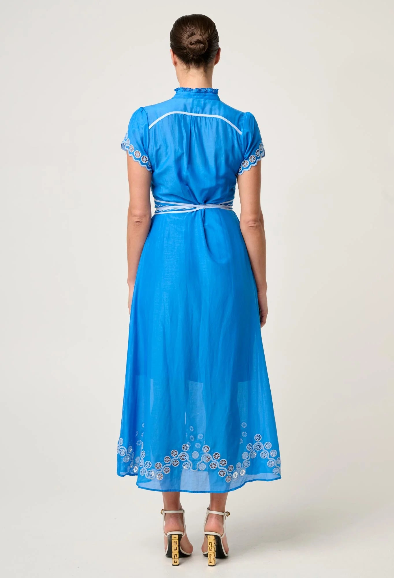 Back studio view of ONCE WAS Xanthia Diamond Smock Yoke Silk Cotton Embroidered Dress in Blue Topaz with embroidered hemline and belted waist.