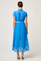 Back studio view of ONCE WAS Xanthia Diamond Smock Yoke Silk Cotton Embroidered Dress in Blue Topaz with embroidered hemline and belted waist.