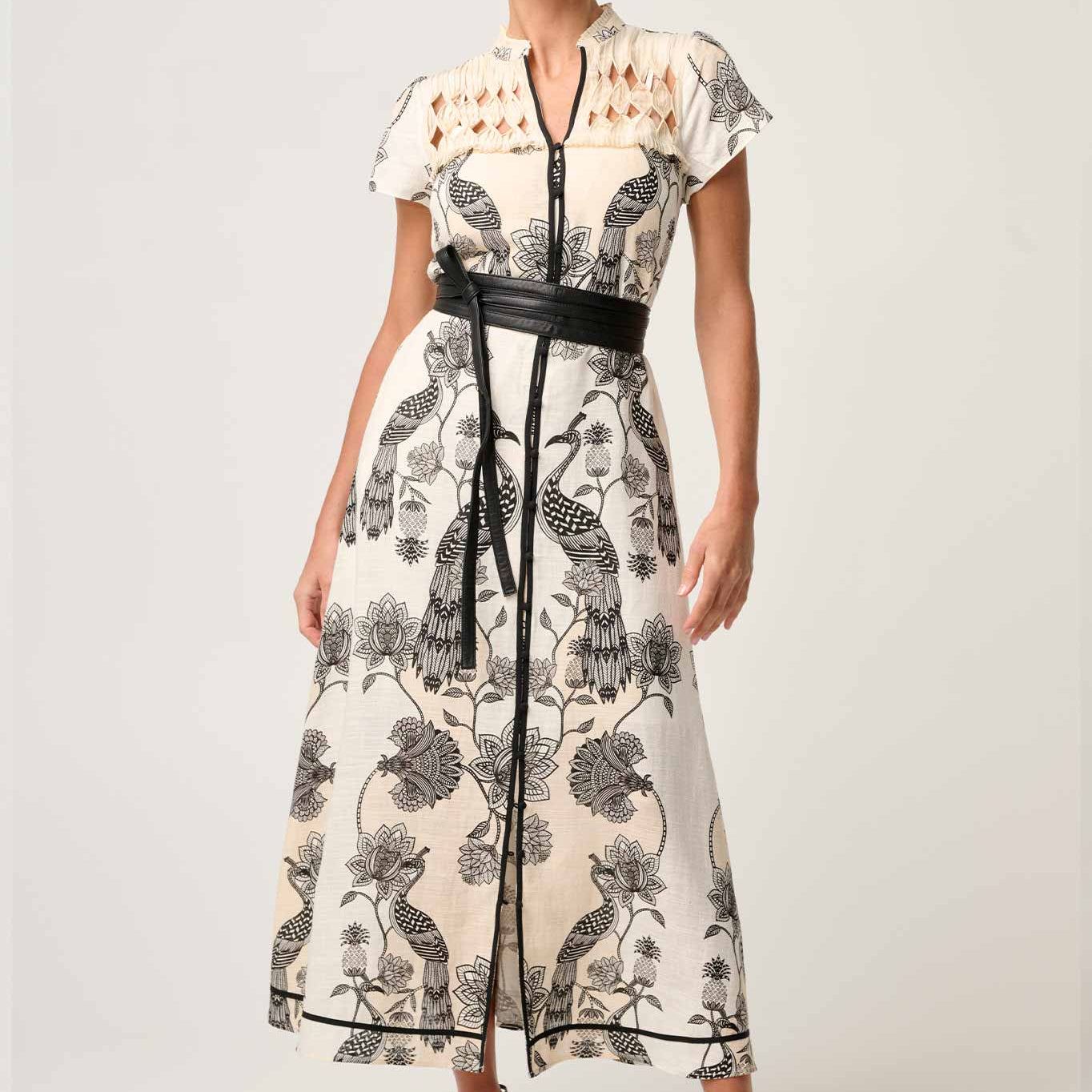 Woman modeling cream and black printed maxi dress with diamond smock yoke and belted waist front view