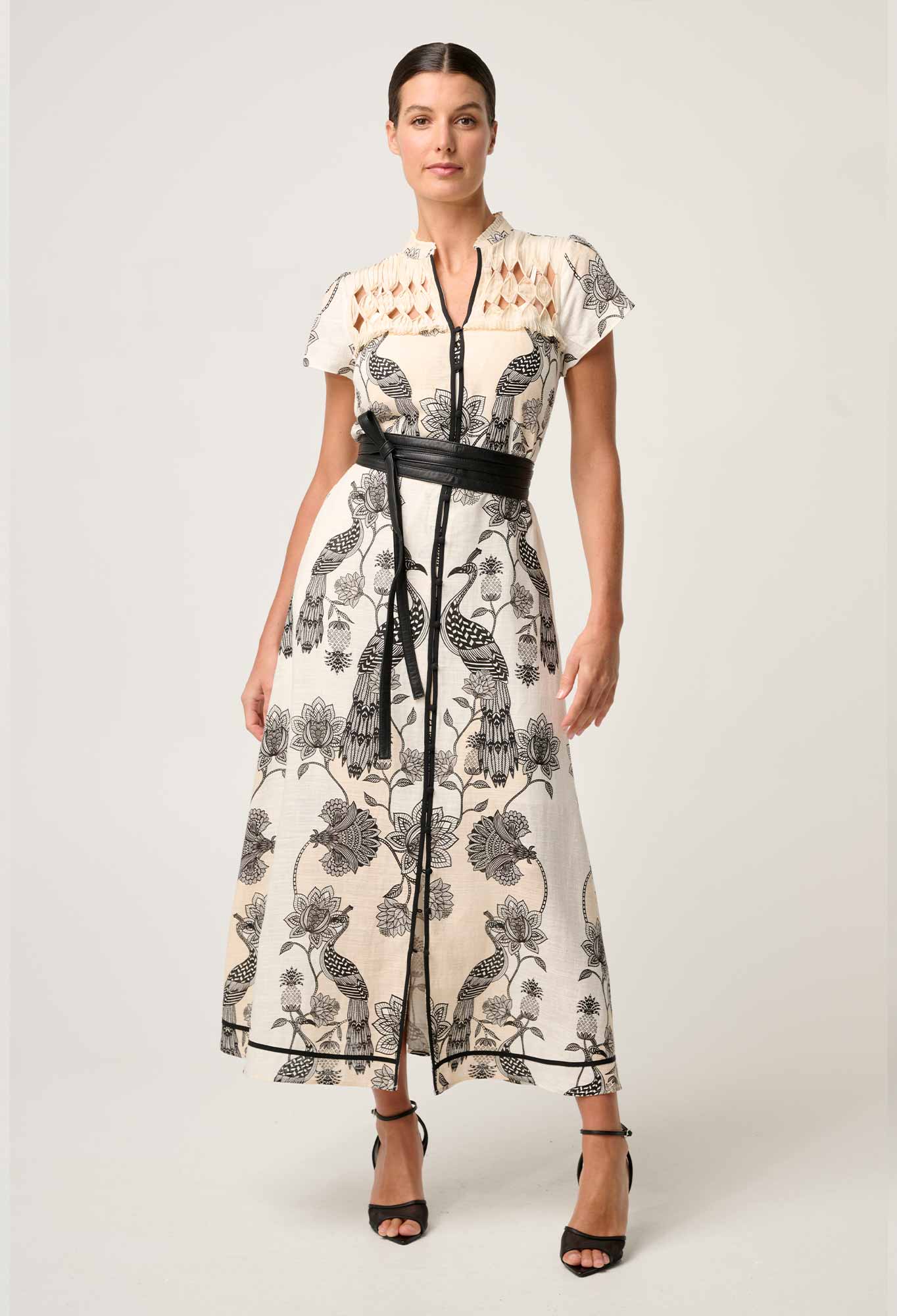 Woman modeling cream and black printed maxi dress with diamond smock yoke and belted waist front view