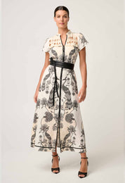 Woman modeling cream and black printed maxi dress with diamond smock yoke and belted waist front view