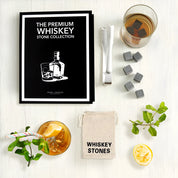 The Premium Whiskey Stone Collection Book Box gift set with whiskey stones, tongs, and storage pouch
