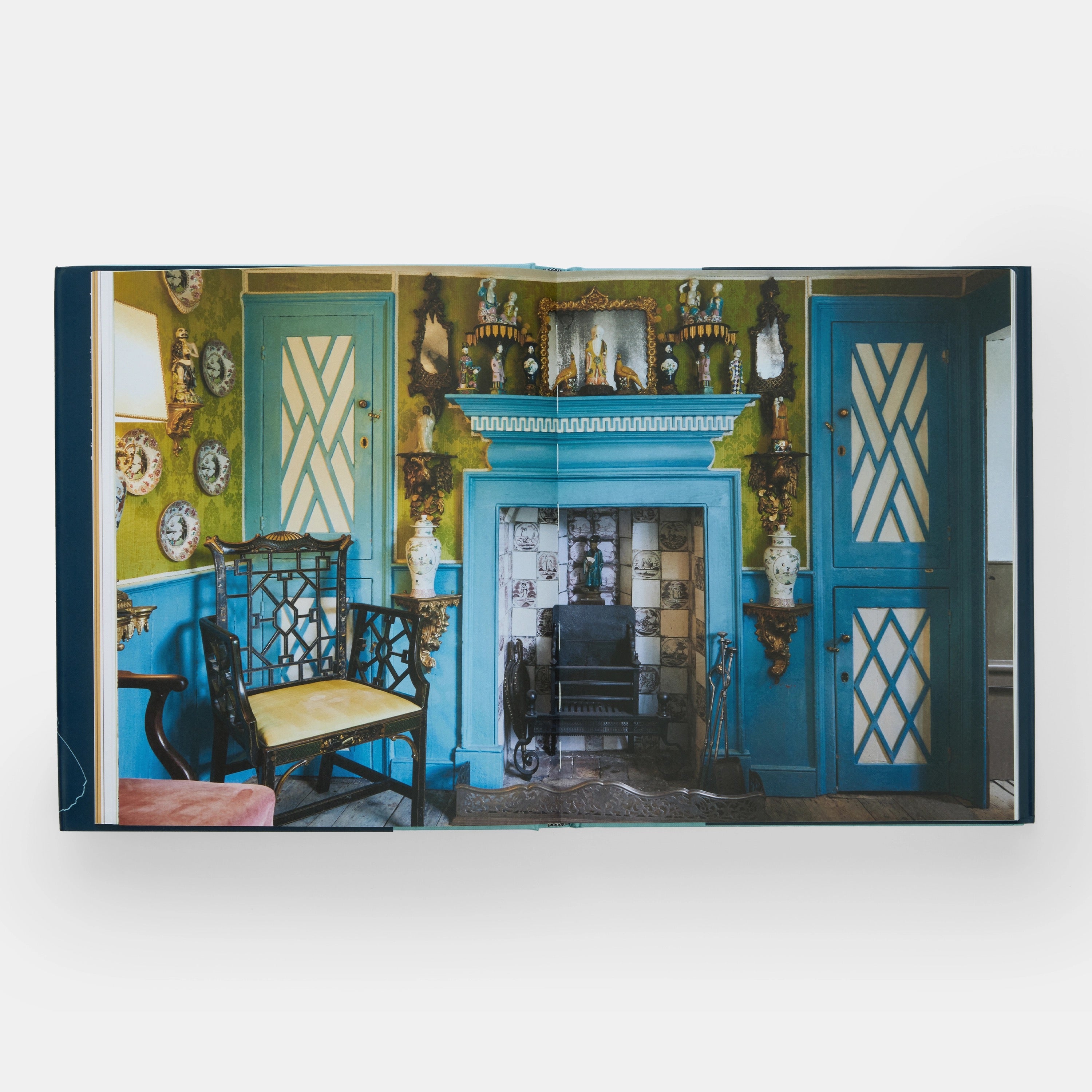 The New Antiquarians book interior showing historic home decor with blue fireplace and antiques